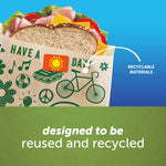 Graphic close-up of a Ziploc recyclable paper bag with printed icons and a visible sandwich, text stating designed to be reused and recycled.