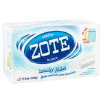 Angled product shot of a Zote Blanco laundry flakes box showing the blue ZOTE logo, soap bar image and light blue packaging design.